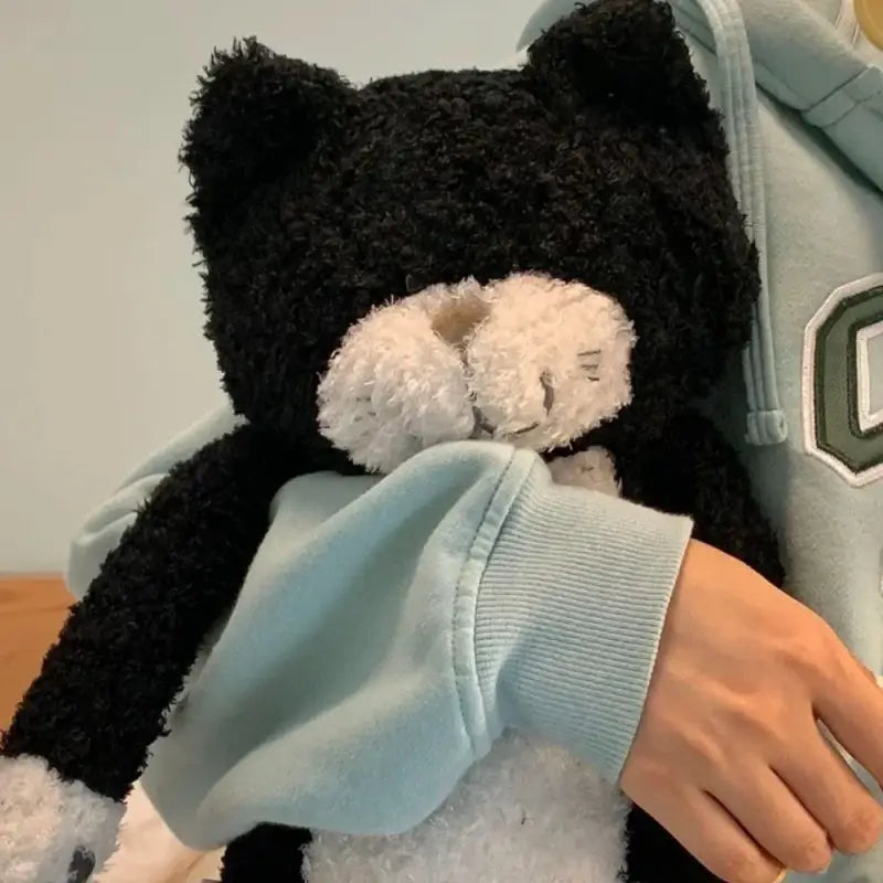 chat en peluche noir et blanc